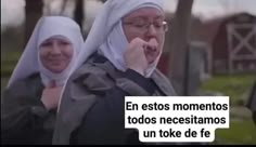 two women with headscarves talking on cell phones