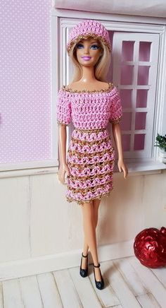 a barbie doll wearing a pink dress and hat