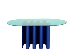 an oval glass table with four blue columns around it and a white wall in the background