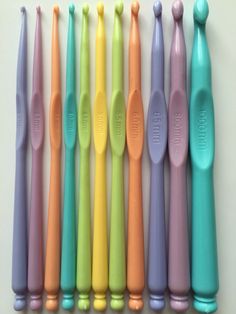 six different colored toothbrushes lined up in a row