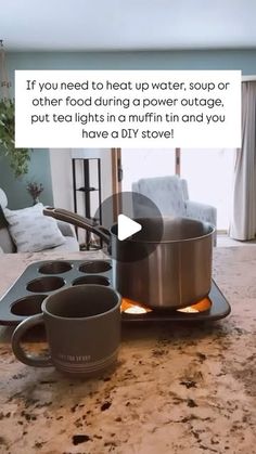 a coffee mug sitting on top of a kitchen counter next to a pan filled with muffins