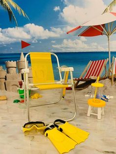 yellow chairs and umbrellas are set up on the beach