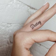 a woman's left hand with a tattoo saying, destroy