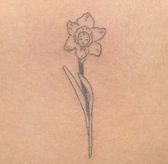 a small flower on the back of a woman's stomach