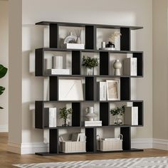 a book shelf filled with lots of books on top of a hard wood floor next to a white wall