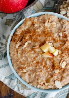 a bowl of oatmeal with apples and nuts