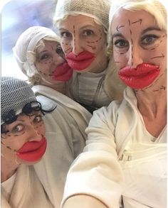 four women with painted faces and noses taking a selfie