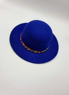 "Kids always love a hat, especially a fun hat like this one! The vacation mood is on This beautiful hat is so stylish and chic, girls will love it. A perfect royal blue wide brim hat for girls is waiting for you to purchase for special occasions autumn or everyday events. A great gift for toddlers!! It's made out of felt and is suited for winter days as well as fall or spring. There are beautiful flowers and butterflies attached to the hat. In each of the flowers and butterflies, there is a shin Blue Spring Felt Hat With Curved Brim, Blue Fedora Felt Hat For Festivals, Blue Adjustable Felt Hat With Short Brim, Bohemian Blue Short Brim Felt Hat, Blue Felt Hat With Flat Brim For Spring, Bohemian Blue Felt Hat With Short Brim, Blue Felt Hat With Flat Brim For Festivals, Blue Bohemian Felt Hat With Short Brim, Blue Brimmed Felt Hat For Festival