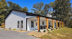 a small white house with yellow trim on the front porch and covered patio area next to it