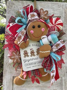 a gingerbread christmas ornament hanging on a sign