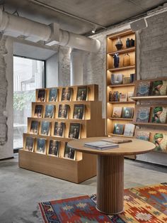 a room with bookshelves and rugs on the floor in front of it