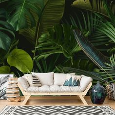 a living room scene with a couch and tropical plants on the wall behind it in front of a rug