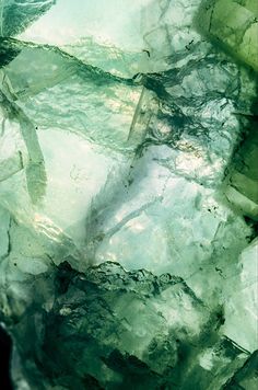 an abstract photograph of green rocks and water