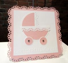 a pink and white congratulations card with a baby carriage