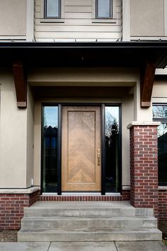 the front door of a house with steps leading up to it