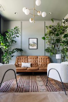 a living room filled with furniture and lots of plants