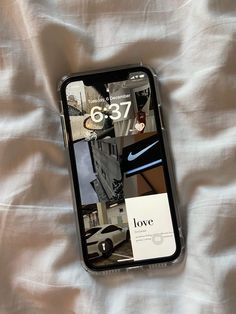 an iphone case with photos on it laying on a white bed sheet in the sun