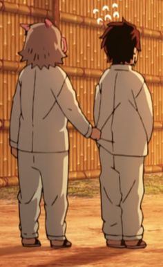 two people standing next to each other holding hands