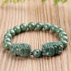 🐉 Jade Pixiu Protection Bracelet - Celestial Healing and Timeless Elegance Channel the power of ancient symbols and the healing energy of crystals with our Jade Pixiu Protection Bracelet. This stunning strand bracelet features natural jade stones, known for their calming and balancing properties, paired with a dragon-engraved Pixiu charm, a powerful symbol of protection and prosperity in Feng Shui. Perfectly blending ethnic style and celestial inspiration, this bracelet is not only a beautiful Spiritual Jade Bracelet Jewelry, Green Jade Crystal Bracelet For Meditation, Pixiu Bracelet, Gold Jade Crystal Bracelet, Spiritual Style, Bohemian Jade Crystal Bracelet Hand-strung, Crystal Healing Bracelets, Protection Bracelet, Meaningful Jewelry, Jade Bracelet