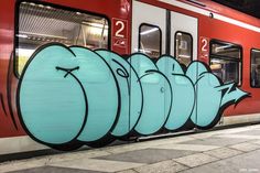 a train that has some graffiti on the side of it's doors and windows