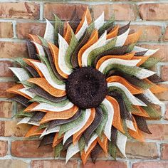 a decorative sunflower on a brick wall