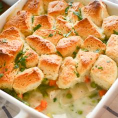 a casserole dish filled with chicken pot pies and garnished with parsley