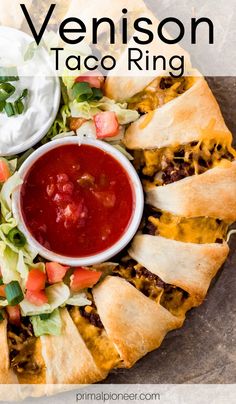 a plate with some taco rings on it and a bowl of salsa in the middle