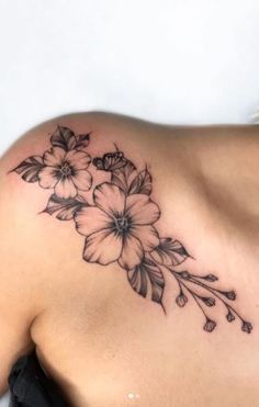 a woman with a flower tattoo on her shoulder