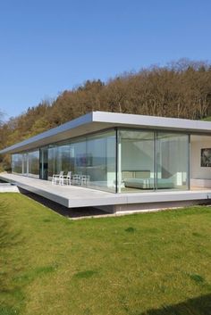 a modern house in the middle of a grassy field