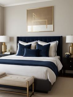 a large bed with blue and white sheets in a bedroom