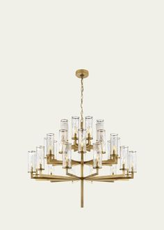 a gold chandelier with clear glass cubes hanging from the middle of it