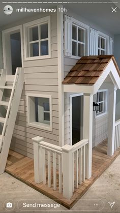 a doll house with stairs to the second floor and windows on the first floor is made out of wood