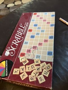 a board game sitting on top of a table next to a pair of pencils