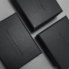 three black leather business cards sitting next to each other