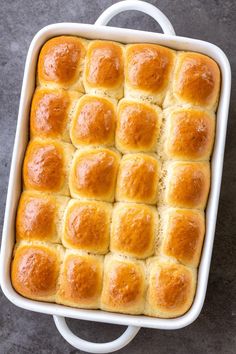 a square casserole dish filled with rolls