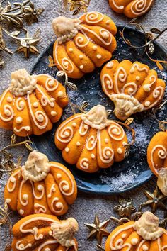 pumpkin shaped cookies with white icing on a plate