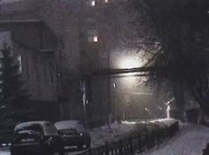 the street is covered in snow at night