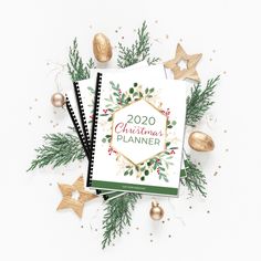 a christmas planner surrounded by ornaments and stars on a white background with the words, 2020 christmas planner