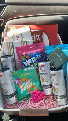 an open car trunk filled with snacks and candy