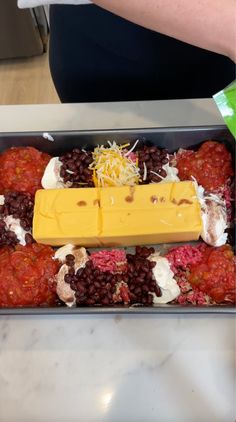 a container filled with lots of food on top of a counter