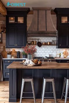 an image of a kitchen setting with black cabinets and stools in the island area