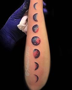 a person with a tattoo on their arm that has phases of the moon in it