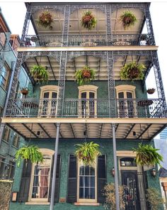 an instagram photo of a building with plants on the balconies