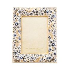 an ornate blue and white frame with flowers on it