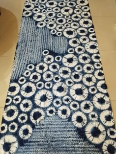 a blue and white rug on the floor