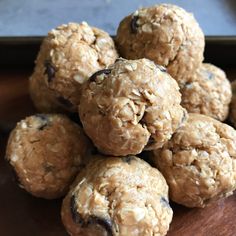 a pile of oatmeal cookies sitting on top of a wooden table