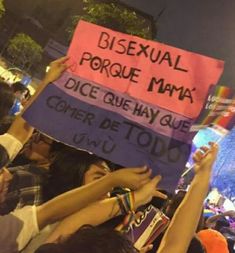 a group of people holding up signs in the air