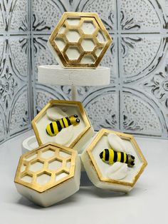 three honeycombs with yellow and black stripes are stacked on top of each other