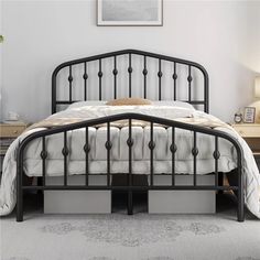 a black metal bed frame with two drawers under the headboard and foot board, in a bedroom