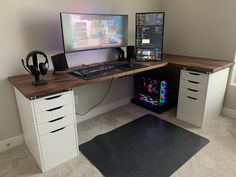 a computer desk with two monitors on top of it and a gaming mouse next to it